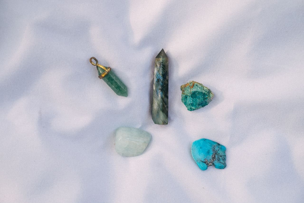 A collection of healing crystals displayed on soft white fabric, perfect for alternative medicine and spiritual practices.